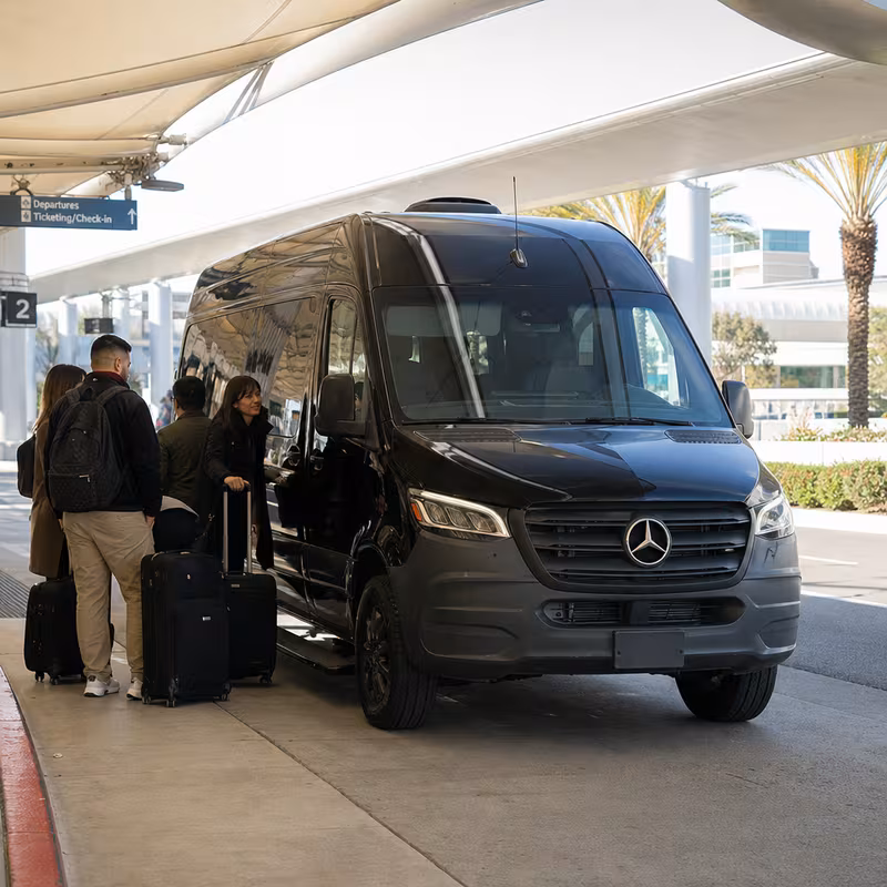 Group boarding a white charter bus for Airport Transportation transportation in Fullerton