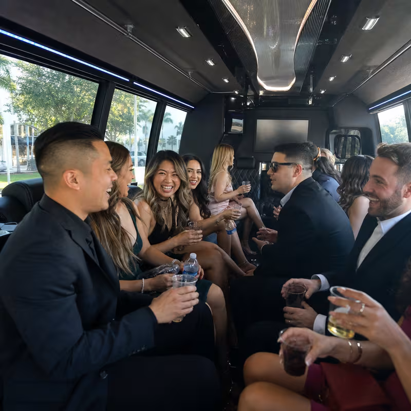 Party bus interior with wraparound leather seating and LED lighting in Fullerton