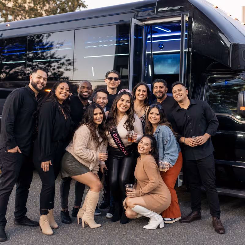 Party bus interior with wraparound leather seating and LED lighting in Fullerton