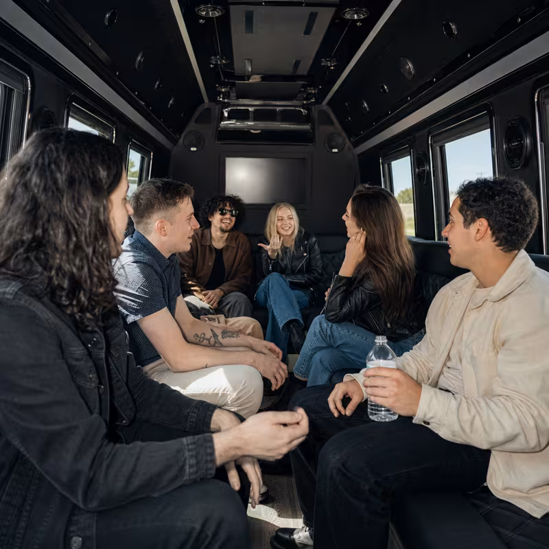 Group boarding a white charter bus for Concert Transportation transportation in Fullerton