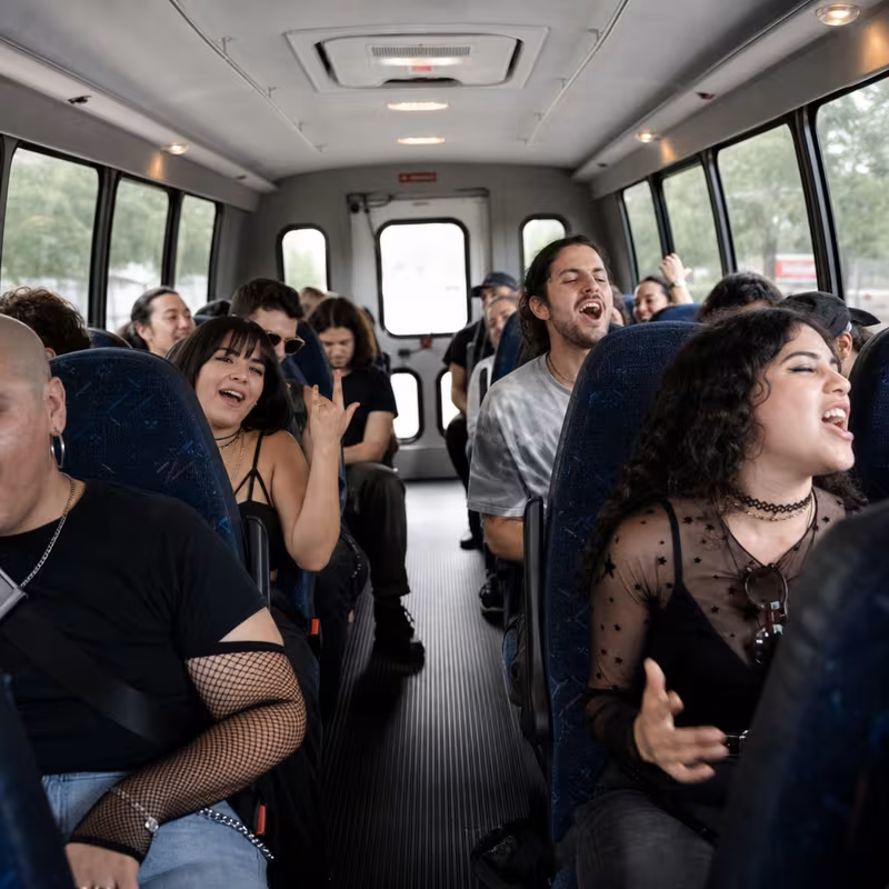 Party bus interior with wraparound leather seating and LED lighting in Fullerton