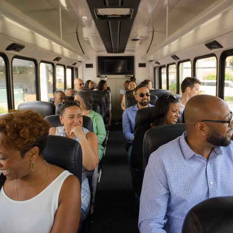 Group boarding a white charter bus for Private Event Transportation transportation in Fullerton