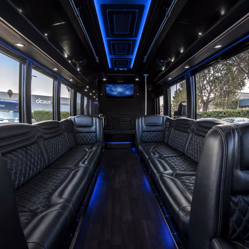 Party bus interior with wraparound leather seating and LED lighting in Fullerton