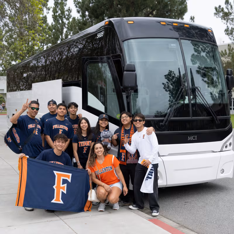 Passengers loading luggage while boarding an Fullerton group shuttle
