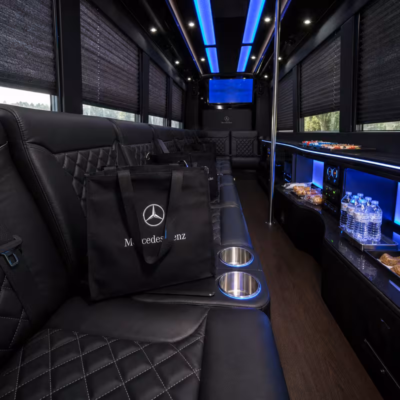 Party bus interior with wraparound leather seating and LED lighting in Fullerton